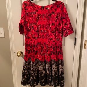 Red floral a-line style dress with 3/4 length sleeves.